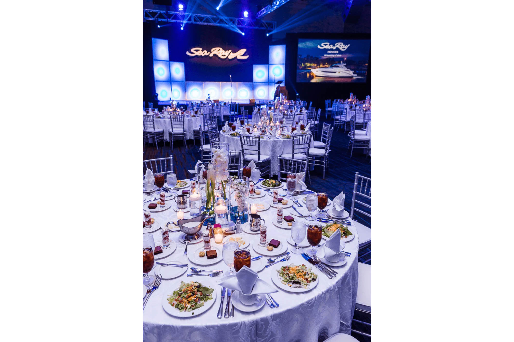 Knoxville corporate event photography of a formal banquet with decorated tables and event stage