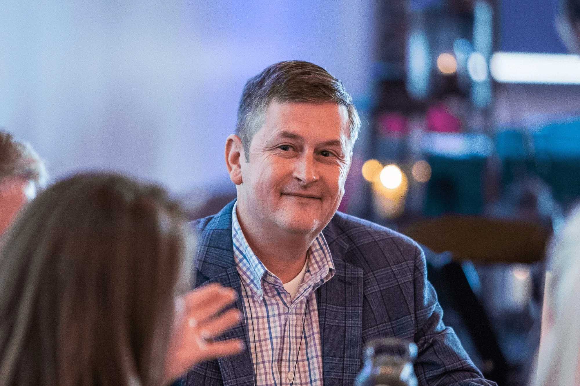 Knoxville corporate event photography of a professional networking with other attendees