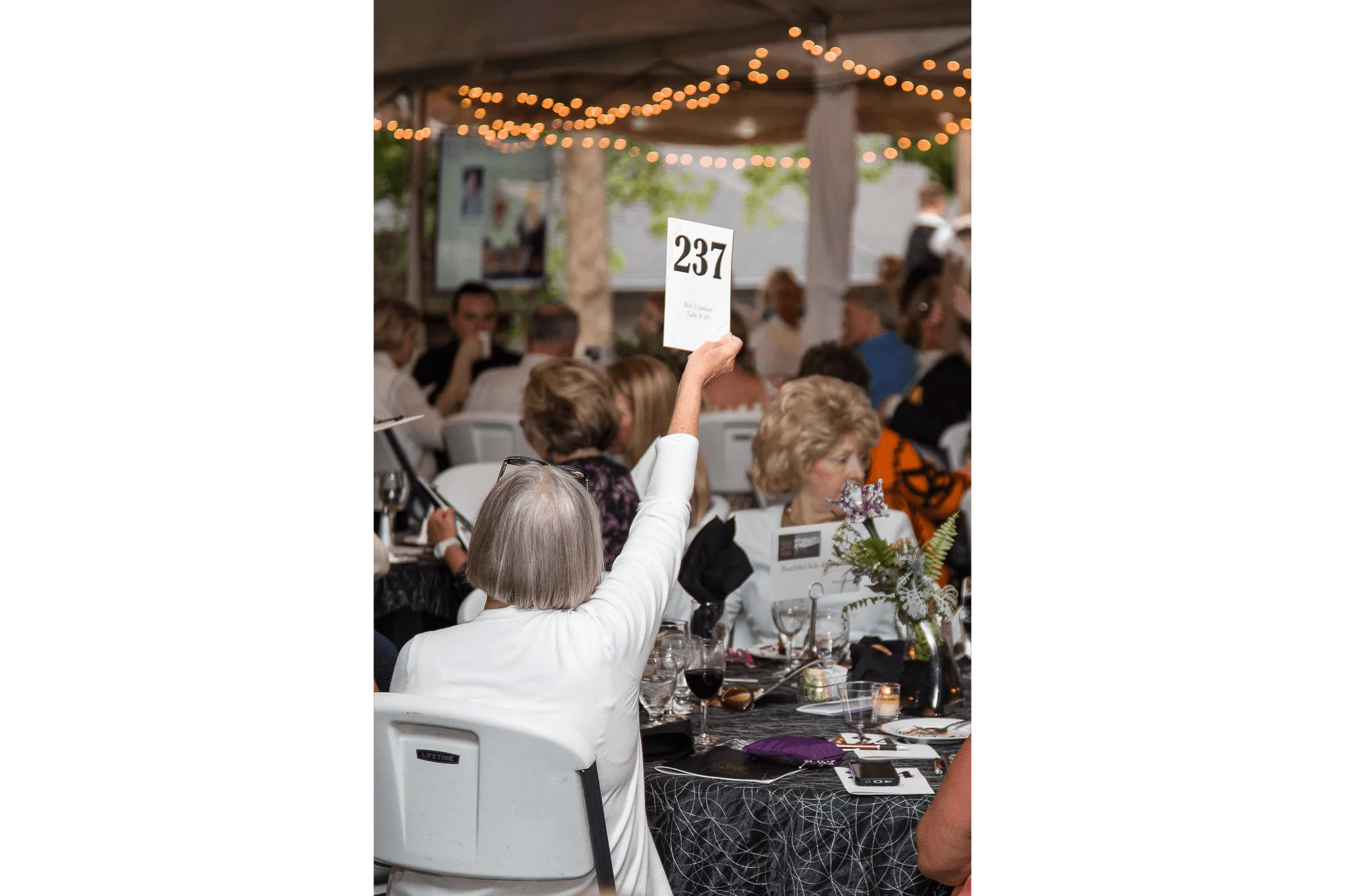 Knoxville corporate event photographer captures a guest bidding during a fundraising auction.