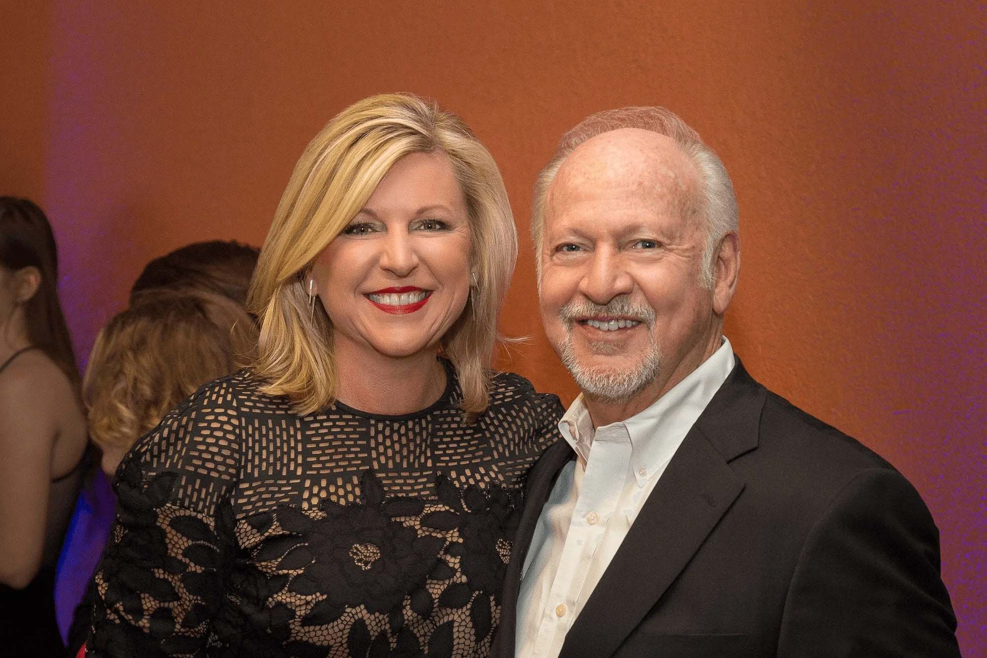 Knoxville corporate event photographer captures two guests posing together at a business event.