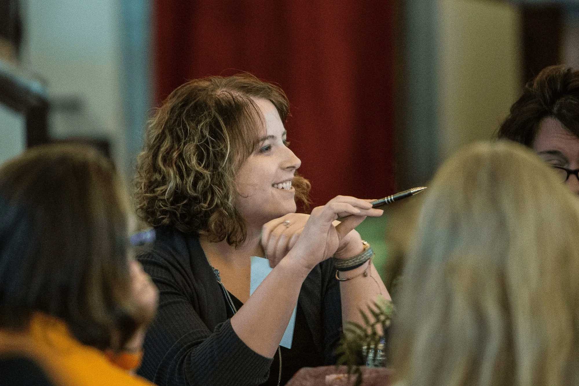Knoxville corporate event photographer captures an attendee participating in a business meeting.